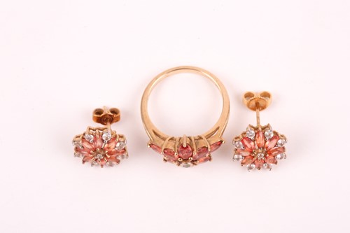 Lot 89 - An orange and white sapphire cluster ring, the...
