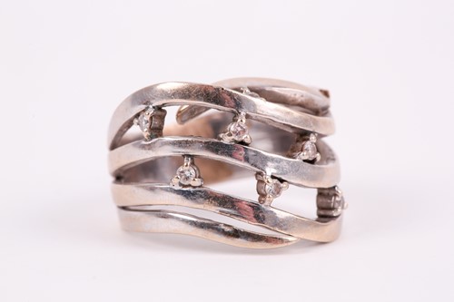 Lot 76 - A white gold and diamond swept band ring, the...