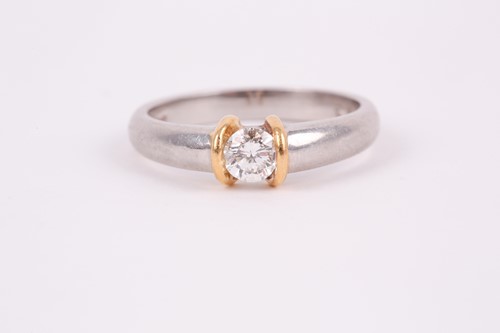 Lot 196 - A platinum and diamond ring, set with a round...