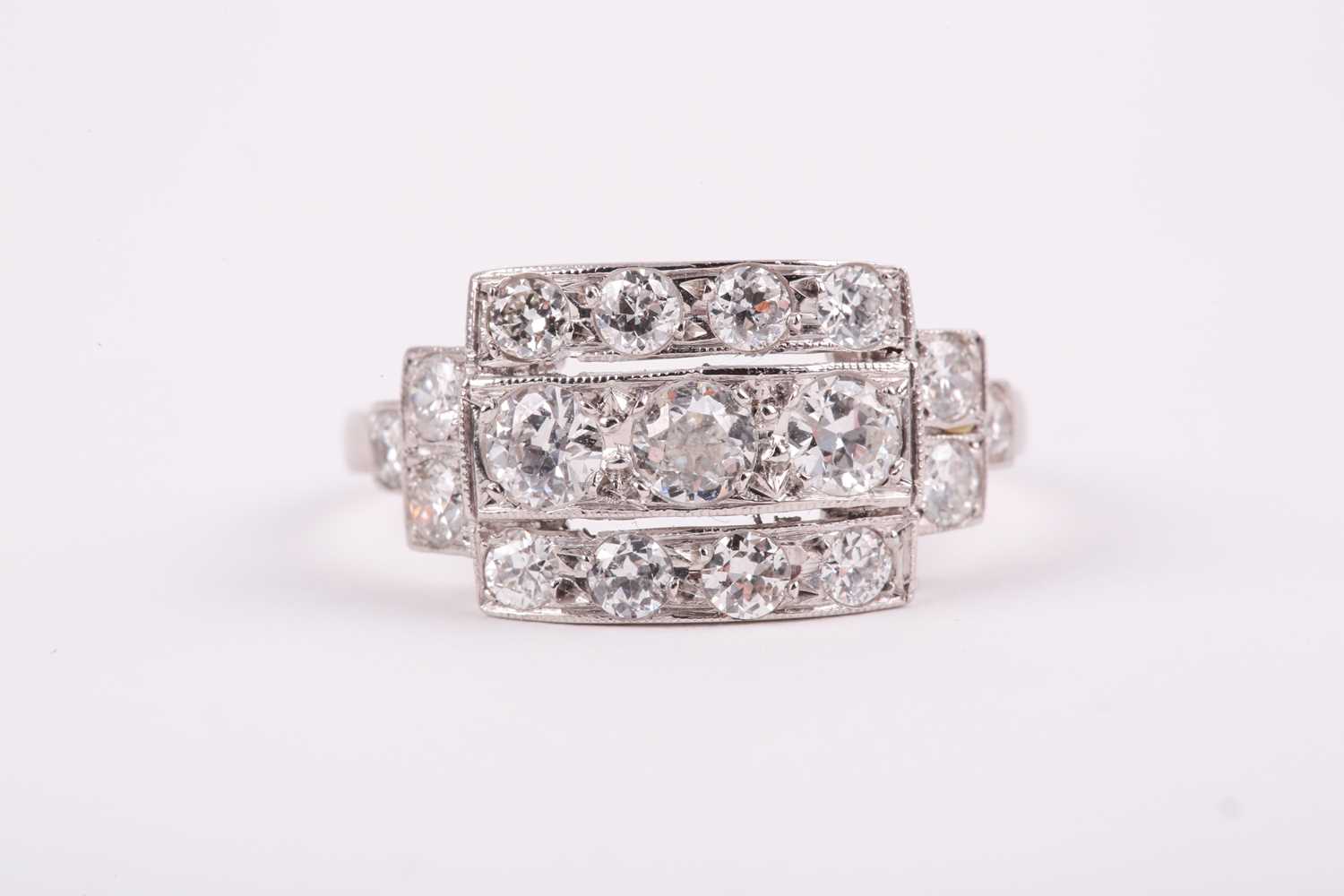 Lot 71 - A platinum and diamond ring, set with three...
