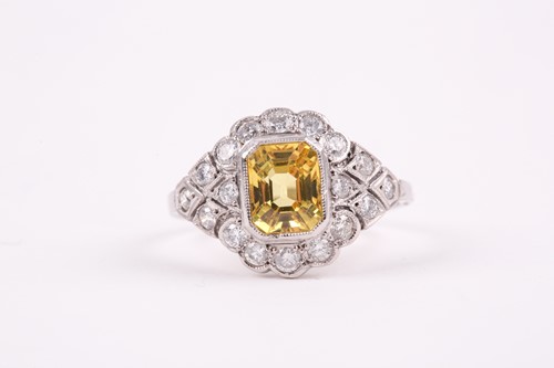 Lot 251 - A platinum, diamond, and yellow sapphire ring,...