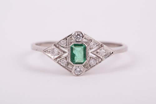 Lot 186 - A platinum, diamond, and emerald ring, the...