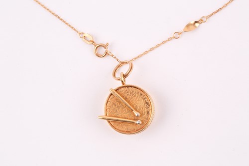 Lot 20 - A yellow metal pendant in the form of a drum...