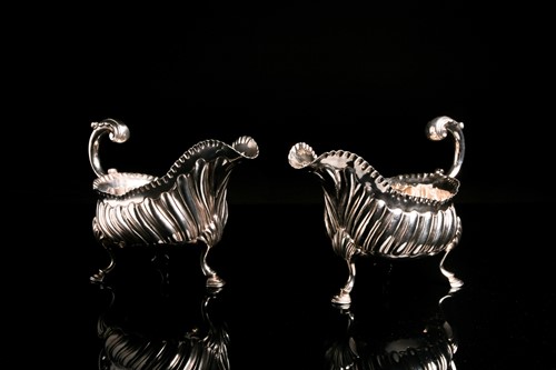 Lot 574 - A pair of George III silver sauce boats, one...