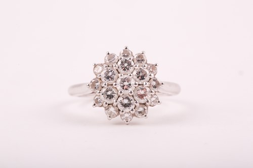 Lot 81 - A diamond cluster ring, the tired three row...