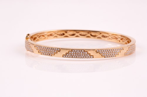 Lot 220 - An 18ct yellow gold and diamond bracelet; the...
