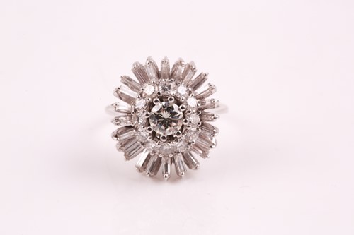 Lot 135 - A diamond cluster ring, the central brilliant...