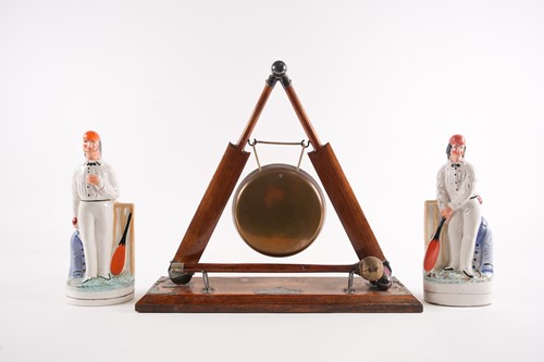 Lot 414 - An early 20th-century oak table gong and...