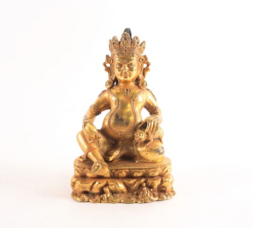Lot 178 - A Sino Tibetan gilt-bronze figure of Jambhala...