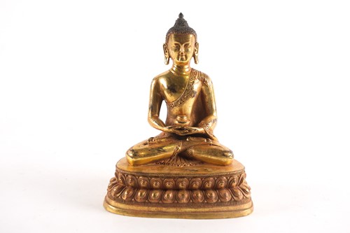 Lot 186 - A Sino Tibetan gilt-bronze figure of a seated...