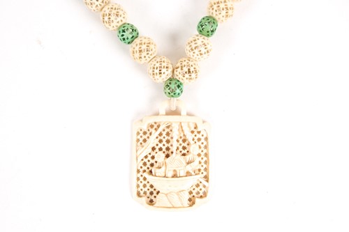 Lot 210 - A Chinese carved ivory pendant, early 20th...
