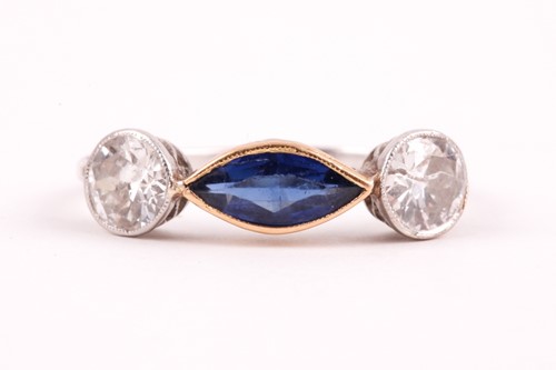 Lot 362 - A diamond and blue stone ring, collet-set east...