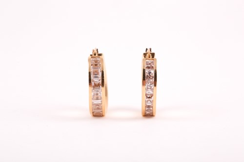 Lot 112 - A pair of yellow metal and cubic zirconia hoop...