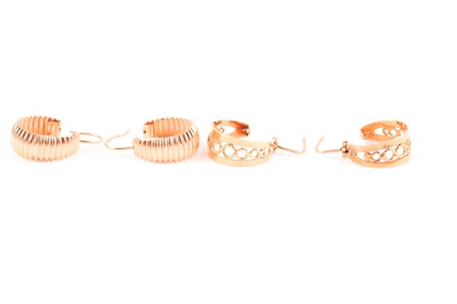Lot 167 - A pair of yellow metal hoop earrings of ribbed...