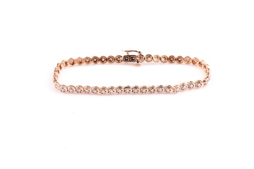 Lot 306 - A 9ct yellow gold and diamond line bracelet,...