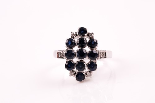Lot 293 - A sapphire and diamond cluster dress ring,...