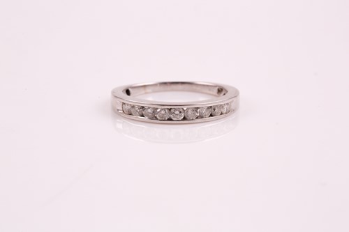 Lot 250 - A nine stone half hoop eternity ring; the...