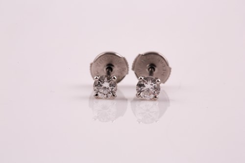 Lot 358 - De Beers. A pair of single stone diamond...