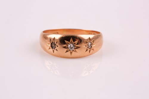 Lot 345 - A three stone diamond ring; the slightly...