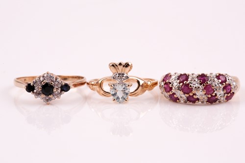 Lot 286 - A three row half hoop ruby and diamond ring,...