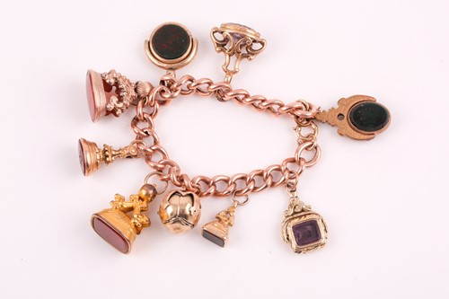Lot 251 - A 9ct rose gold Victorian curb-link charm...