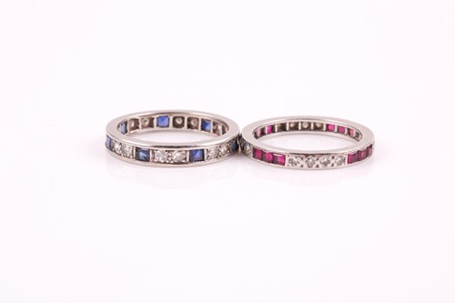 Lot 204 - A diamond and sapphire eternity ring, set with...