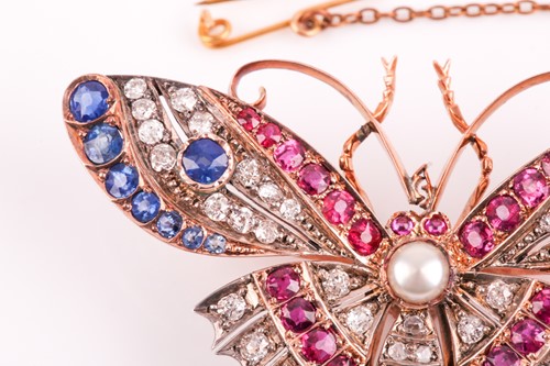 Lot 282 - A diamond, ruby, and sapphire butterfly brooch,...