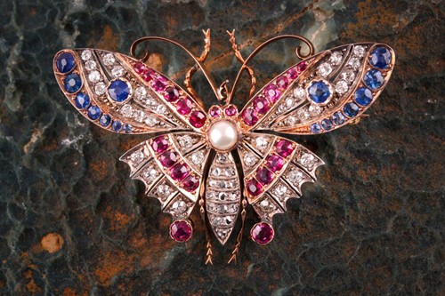 Lot 282 - A diamond, ruby, and sapphire butterfly brooch,...