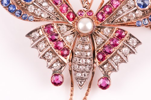 Lot 282 - A diamond, ruby, and sapphire butterfly brooch,...