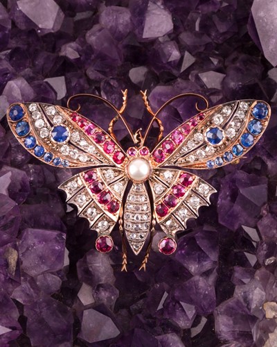 Lot 282 - A diamond, ruby, and sapphire butterfly brooch,...