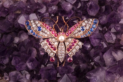 Lot 282 - A diamond, ruby, and sapphire butterfly brooch,...