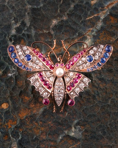 Lot 282 - A diamond, ruby, and sapphire butterfly brooch,...