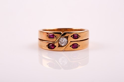 Lot 318 - A two row ruby and diamond ring; the central...