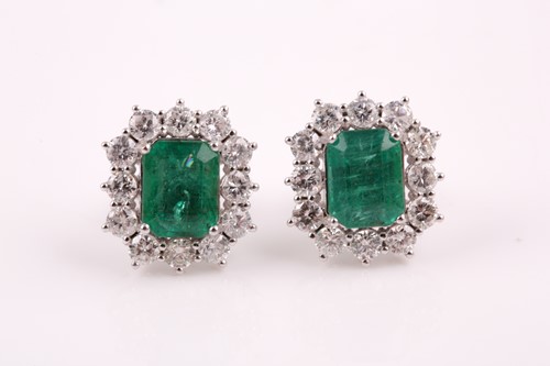 Lot 314 - A pair of diamond and emerald earrings, set...
