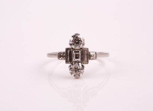 Lot 65 - An Art Deco diamond ring; set with two round...