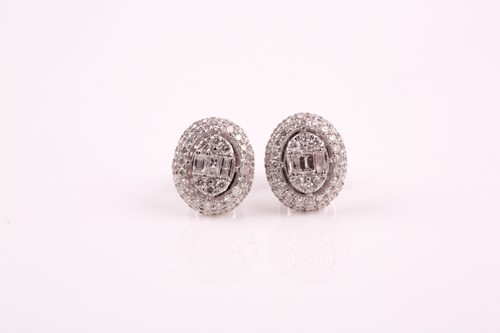 Lot 104 - A pair of white gold and diamond oval cluster...