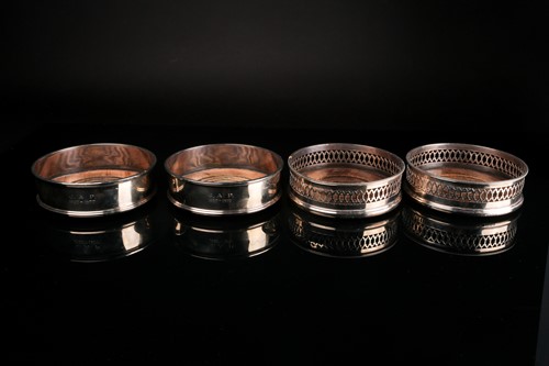Lot 480 - Two pairs of silver wine bottle coasters, C J...