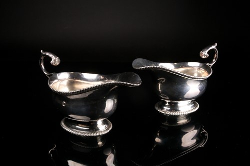 Lot 479 - A pair of silver gravy boats, Harrods, London...