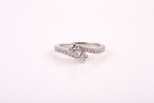 Lot 178 - A 14k white gold and diamond crossover ring,...