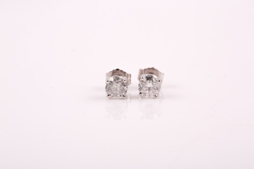 Lot 221 - A pair of solitaire diamond earrings, the...