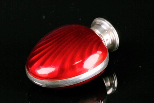 Lot 491 - A silver and enamel scent bottle, of oval...