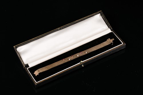 Lot 203 - A 9ct yellow gold, diamond, and ruby bracelet,...