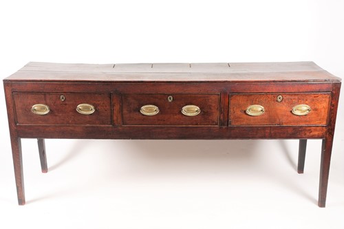 Lot 257 - A George III oak three drawer dresser base...