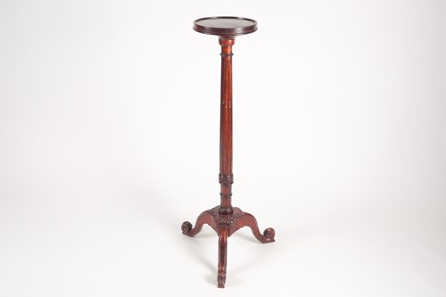 Lot 277 - A George III style stained wood torchere with...