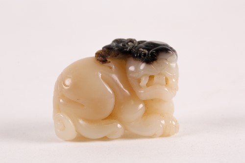 Lot 127 - A Chinese, carved off-white and grey jade,...