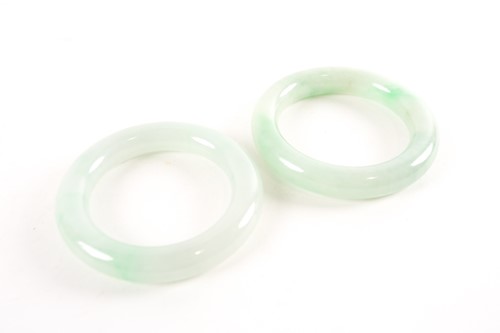 Lot 80 - A near pair of Chinese jade bangles, each...