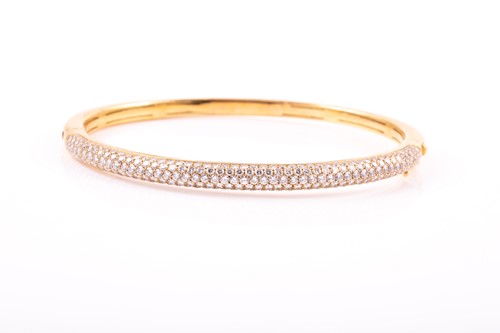 Lot 228 - An 18ct gold and diamond bangle, the hinged D...