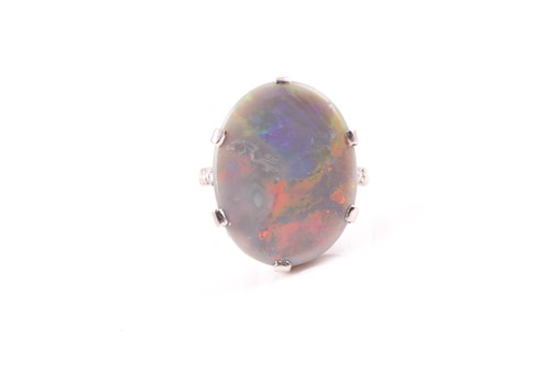 Lot 37 - An 18ct yellow gold and black opal ring, set...