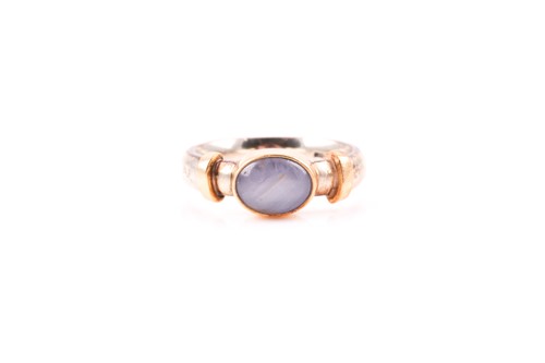 Lot 194 - A 9ct yellow and white gold and star sapphire...