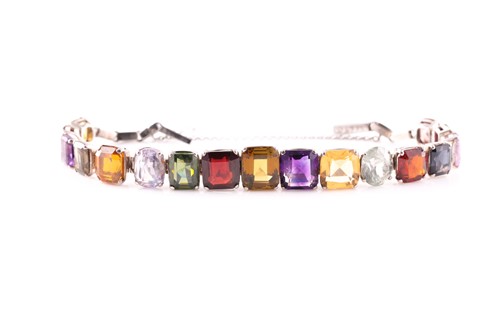Lot 98 - A graduated multi-gem set bracelet, the...